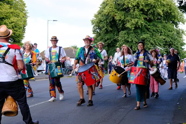 Colourful carnival procession moving through the streets of Dawlish