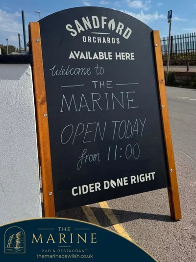 Pavement sign advertising The Marine is open for business